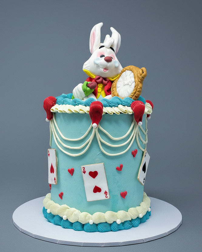 Decorative cake with a rabbit figure and card design on a gray background