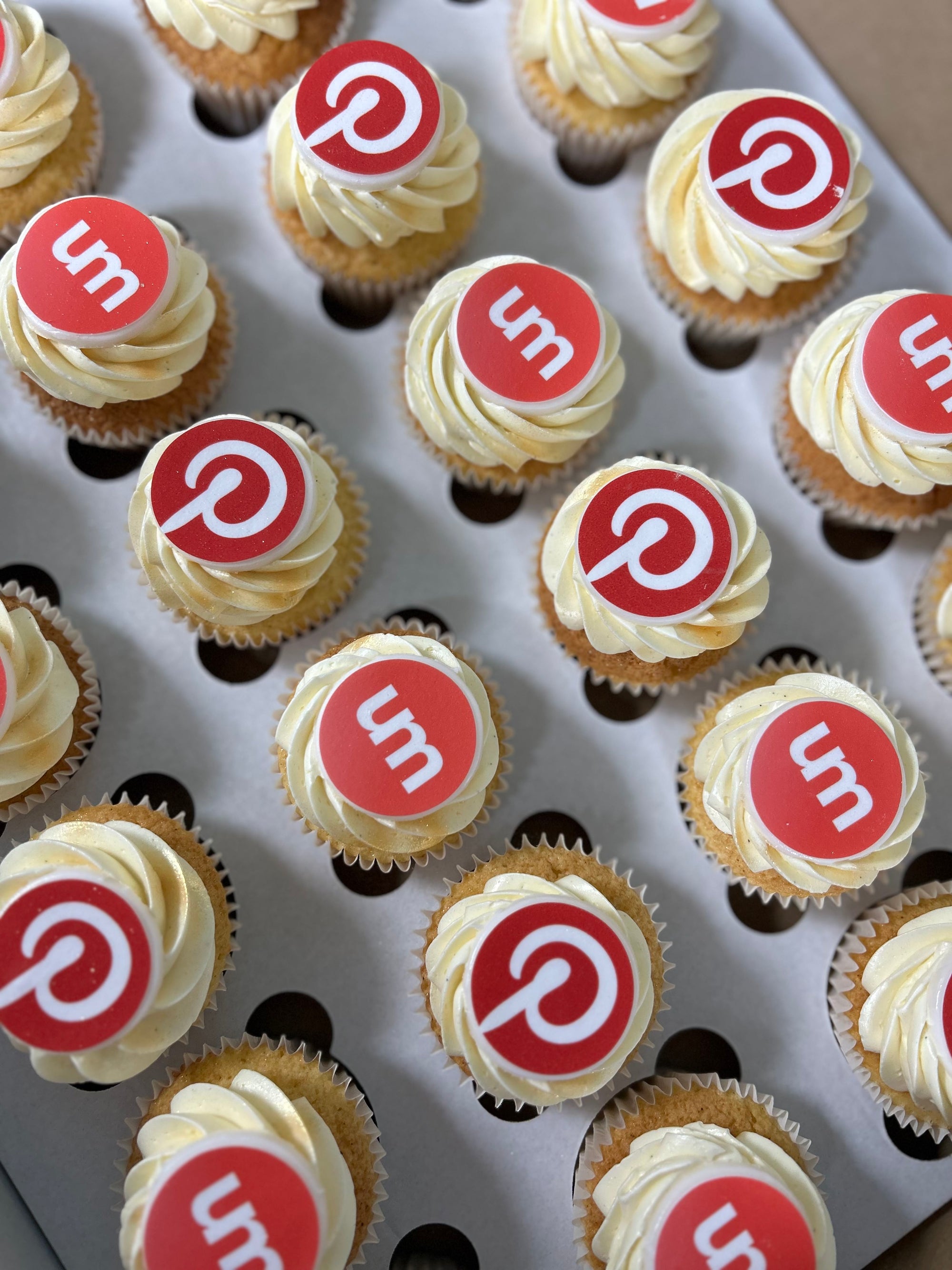 Cupcakes with Pinterest and Umbraco logos arranged on a tray.