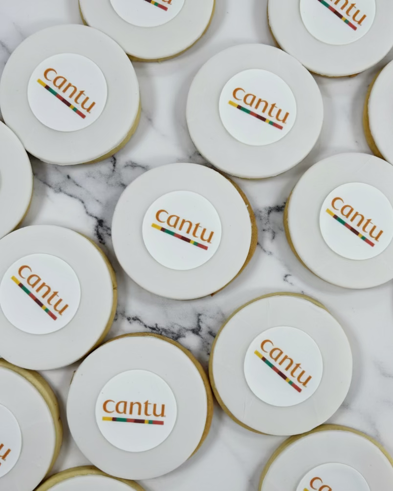 Round biscuits with 'cantu' branding on a baking sheet