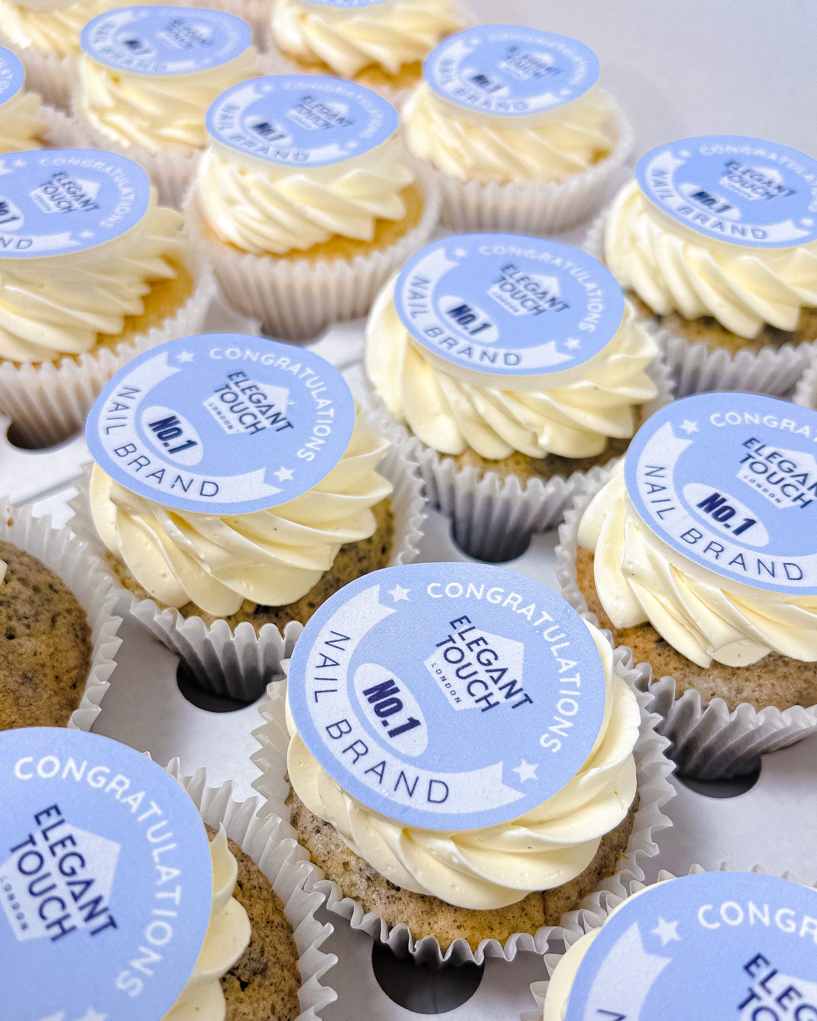 Cupcakes with 'Elegant Touch' branding on a white background