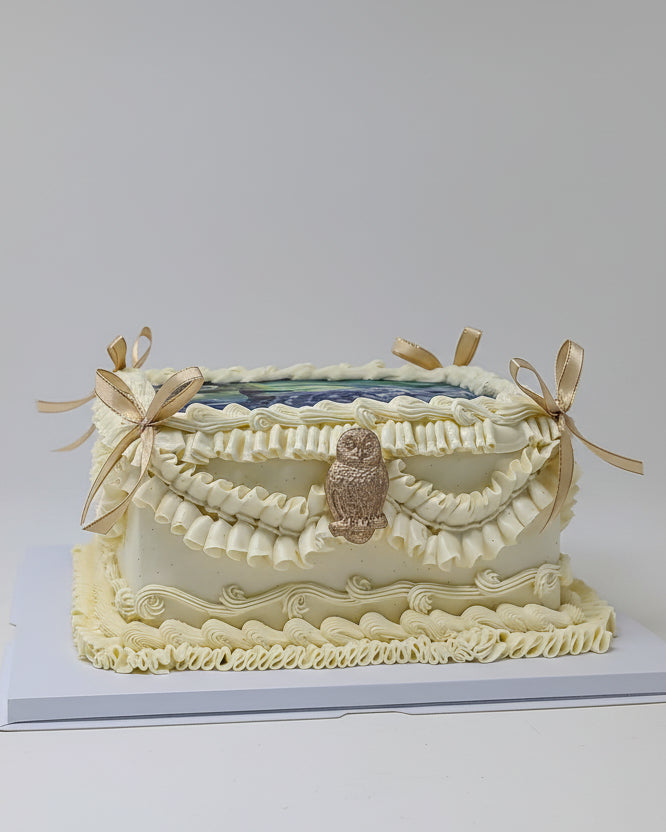 Decorative cake with owl design on a white background